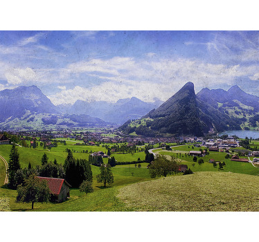 Rolgordijn woonkamer huizen op een groen veld met bergen - TenStickers