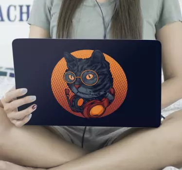 laptop sking cover featuring a cat with glasses and headphones on a black background. It can be applied and can be removed whenever you want to.