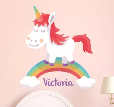 A personalised children's wall sticker of a sweet looking unicorn standing on a rainbow. Add any name that you like to make it more personal to you!