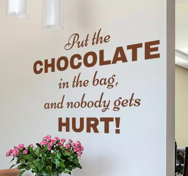 A funny wall quote sticker with the words; 'Put the chocolate in the bag and nobody gets hurt'! Ideal for creating a light-hearted atmosphere.